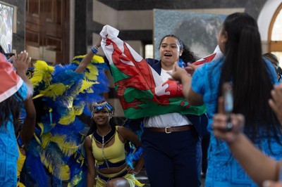 170825 - Women’s Rugby World Cup Welcome Ceremony - Wales’ Sisilia Tuipulotu take the Wales flag and joins in with the welcome dance troop at the Women’s Rugby World Cup welcome ceremony at Manchester Town Hall