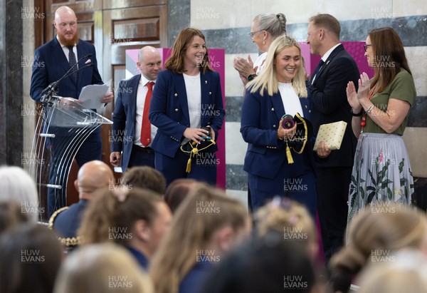 170825 - Women’s Rugby World Cup Welcome Ceremony - Wales co-captains Alex Callendar and Kate Williams and Sean Lynn, Wales Women head coach receive their caps and participation medal at the Women’s Rugby World Cup welcome ceremony at Manchester Town Hall