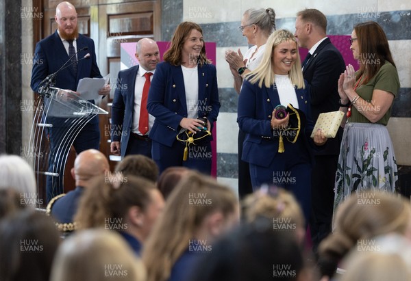 170825 - Women’s Rugby World Cup Welcome Ceremony - Wales co-captains Alex Callendar and Kate Williams and Sean Lynn, Wales Women head coach receive their caps and participation medal at the Women’s Rugby World Cup welcome ceremony at Manchester Town Hall