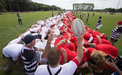 240816 - World Record attempt for the Largest Rugby Scrum - Participants bind together ready for the ball as the attempt for the Worlds Largest Rugby Scrum gets underway at the Golden Oldies World Rugby Festival in Cardiff