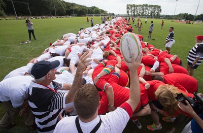 240816 - World Record attempt for the Largest Rugby Scrum - Participants bind together ready for the ball as the attempt for the Worlds Largest Rugby Scrum gets underway at the Golden Oldies World Rugby Festival in Cardiff