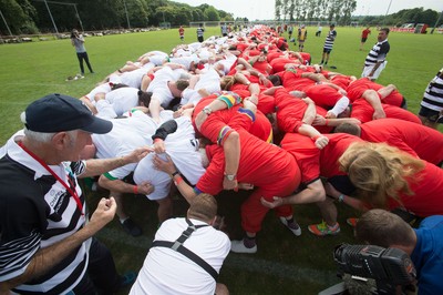 240816 - World Record attempt for the Largest Rugby Scrum - Participants bind together ready for the ball as the attempt for the Worlds Largest Rugby Scrum gets underway at the Golden Oldies World Rugby Festival in Cardiff