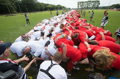 240816 - World Record attempt for the Largest Rugby Scrum - Participants bind together ready for the ball as the attempt for the Worlds Largest Rugby Scrum gets underway at the Golden Oldies World Rugby Festival in Cardiff