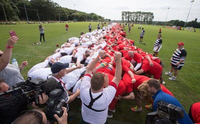 240816 - World Record attempt for the Largest Rugby Scrum - Participants bind together ready for the ball as the attempt for the Worlds Largest Rugby Scrum gets underway at the Golden Oldies World Rugby Festival in Cardiff