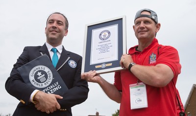 240816 - World Record attempt for the Largest Rugby Scrum - Jack Brockbank, adjudicator for Guinness World Records, presents the certificate for the new World Record for the Largest Rugby Scrum at 1297 people to Mark Marriott, Scrum co-ordinator at the Golden Oldies World Rugby Festival in Cardiff