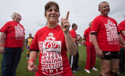 240816 - World Record attempt for the Largest Rugby Scrum - Participants wait to bind together as the attempt for the Worlds Largest Rugby Scrum gets underway at the Golden Oldies World Rugby Festival in Cardiff The new record of 1297 was successful