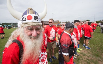 240816 - World Record attempt for the Largest Rugby Scrum - Participants wait to bind together as the attempt for the Worlds Largest Rugby Scrum gets underway at the Golden Oldies World Rugby Festival in Cardiff The new record of 1297 was successful