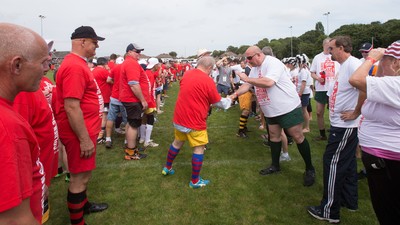 240816 - World Record attempt for the Largest Rugby Scrum - Participants wait to bind together as the attempt for the Worlds Largest Rugby Scrum gets underway at the Golden Oldies World Rugby Festival in Cardiff The new record of 1297 was successful