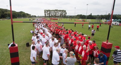 240816 - World Record attempt for the Largest Rugby Scrum - Participants wait to bind together as the attempt for the Worlds Largest Rugby Scrum gets underway at the Golden Oldies World Rugby Festival in Cardiff The new record of 1297 was successful