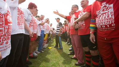 240816 - World Record attempt for the Largest Rugby Scrum - Participants wait to bind together as the attempt for the Worlds Largest Rugby Scrum gets underway at the Golden Oldies World Rugby Festival in Cardiff The new record of 1297 was successful