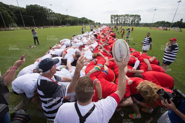 240816 - World Record attempt for the Largest Rugby Scrum - Participants bind together ready for the ball as the attempt for the Worlds Largest Rugby Scrum gets underway at the Golden Oldies World Rugby Festival in Cardiff