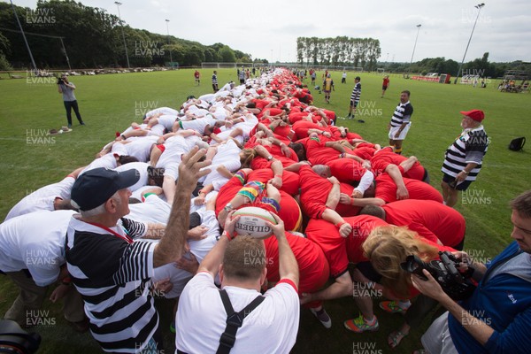 240816 - World Record attempt for the Largest Rugby Scrum - Participants bind together ready for the ball as the attempt for the Worlds Largest Rugby Scrum gets underway at the Golden Oldies World Rugby Festival in Cardiff
