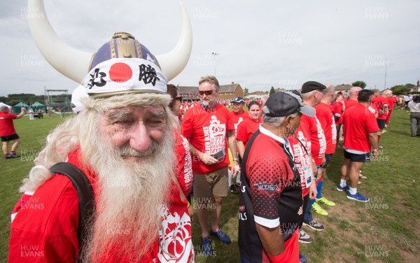 240816 - World Record attempt for the Largest Rugby Scrum - Participants wait to bind together as the attempt for the Worlds Largest Rugby Scrum gets underway at the Golden Oldies World Rugby Festival in Cardiff The new record of 1297 was successful