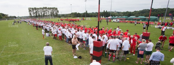 240816 - World Record attempt for the Largest Rugby Scrum - Participants wait to bind together as the attempt for the Worlds Largest Rugby Scrum gets underway at the Golden Oldies World Rugby Festival in Cardiff The new record of 1297 was successful