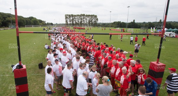 240816 - World Record attempt for the Largest Rugby Scrum - Participants wait to bind together as the attempt for the Worlds Largest Rugby Scrum gets underway at the Golden Oldies World Rugby Festival in Cardiff The new record of 1297 was successful