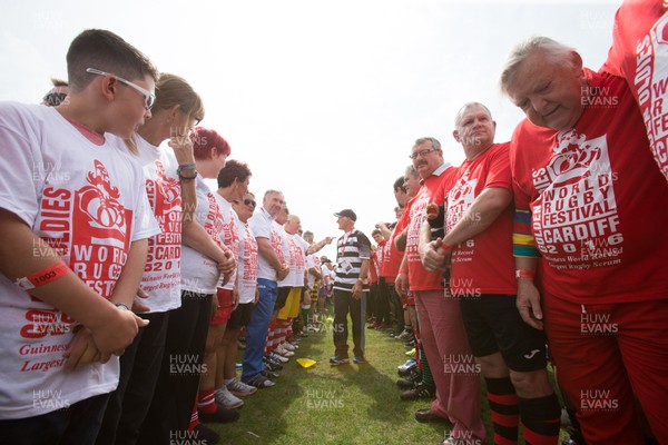 240816 - World Record attempt for the Largest Rugby Scrum - Participants wait to bind together as the attempt for the Worlds Largest Rugby Scrum gets underway at the Golden Oldies World Rugby Festival in Cardiff The new record of 1297 was successful