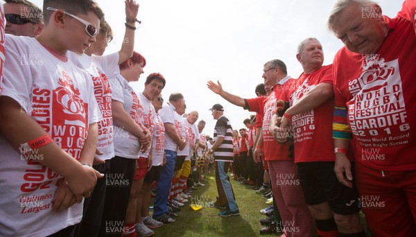 240816 - World Record attempt for the Largest Rugby Scrum - Participants wait to bind together as the attempt for the Worlds Largest Rugby Scrum gets underway at the Golden Oldies World Rugby Festival in Cardiff The new record of 1297 was successful