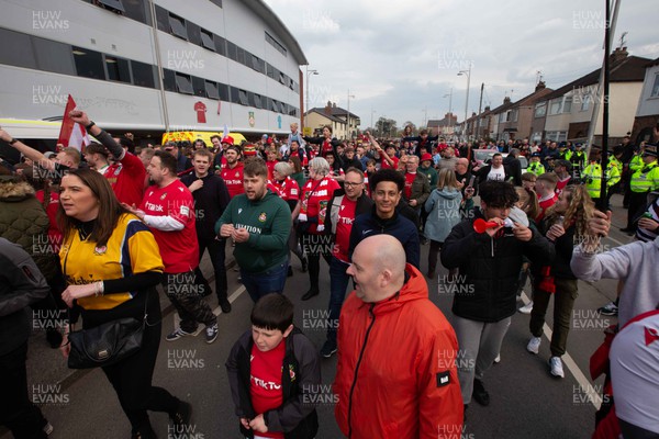 220423 - Wrexham v Boreham Wood - Vanarama National League - 12th man march by fans up to the Racecourse