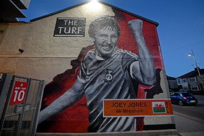 281025 - Wrexham v Cardiff City - Carabao Cup Round 4 - A mural of ex Wrexham player Joey Jones on the Famous Turf pub outside the Stok Racecourse ground in Wrexham
