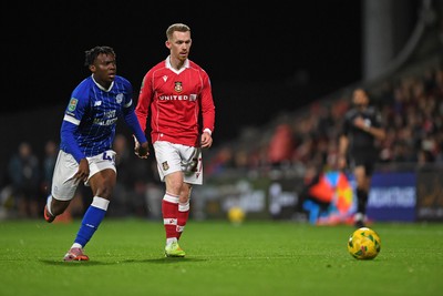 281025 - Wrexham v Cardiff City - Carabao Cup Round 4 - Lewis O'Brien of Wrexham is challenged by Ronan Kpakio of Cardiff City