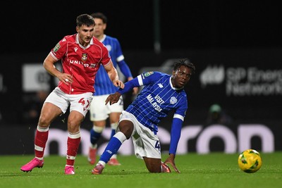 281025 - Wrexham v Cardiff City - Carabao Cup Round 4 - Ryan Longman of Wrexham is challenged by Ronan Kpakio of Cardiff City