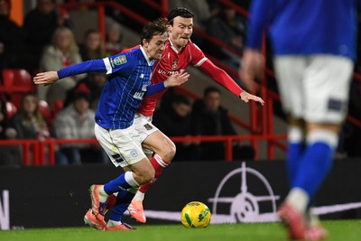 281025 - Wrexham v Cardiff City - Carabao Cup Round 4 - Kieffer Moore of Wrexham is challenged by Ryan Wintle of Cardiff City