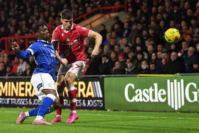 281025 - Wrexham v Cardiff City - Carabao Cup Round 4 - Ryan Longman of Wrexham is challenged by Ronan Kpakio of Cardiff City