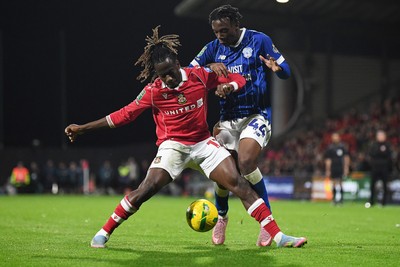 281025 - Wrexham v Cardiff City - Carabao Cup Round 4 - Issa Kabore of Wrexham is challenged by Ronan Kpakio of Cardiff City