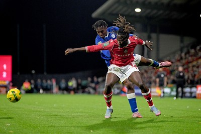 281025 - Wrexham v Cardiff City - Carabao Cup Round 4 - Issa Kabore of Wrexham is challenged by Ronan Kpakio of Cardiff City