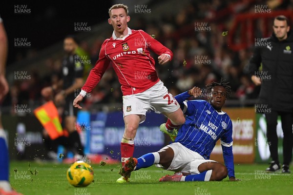 281025 - Wrexham v Cardiff City - Carabao Cup Round 4 - Lewis O'Brien of Wrexham is challenged by Ronan Kpakio of Cardiff City