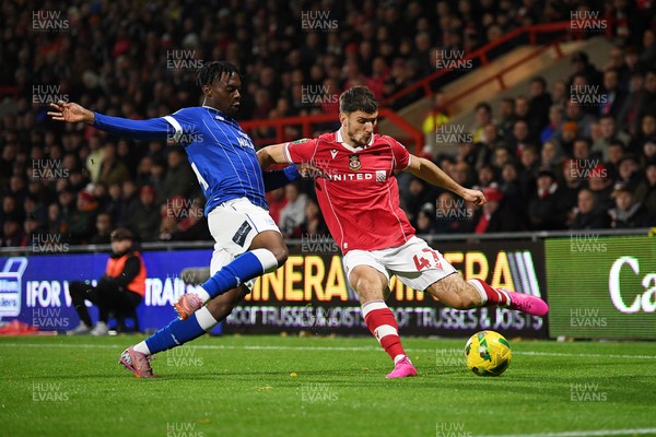 281025 - Wrexham v Cardiff City - Carabao Cup Round 4 - Ryan Longman of Wrexham is challenged by Ronan Kpakio of Cardiff City