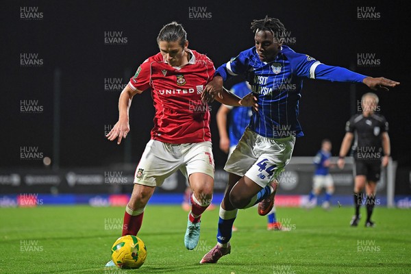 281025 - Wrexham v Cardiff City - Carabao Cup Round 4 - George Dobson of Wrexham is challenged by Ronan Kpakio of Cardiff City