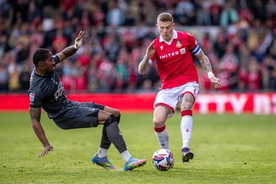 260425 - Wrexham v Charlton Athletic - Sky Bet League 1 - Tennai Watson of Charlton Athletic challenges James McClean of Wrexham AFC