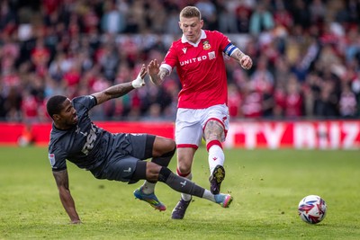 260425 - Wrexham v Charlton Athletic - Sky Bet League 1 - Tennai Watson of Charlton Athletic challenges James McClean of Wrexham AFC