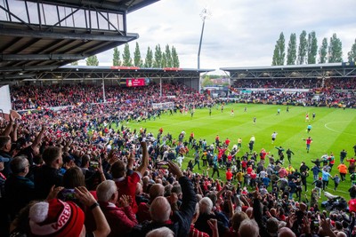 260425 - Wrexham v Charlton Athletic - Sky Bet League 1 - Wrexham fans celebrate at full time following their promotion securing victory over Charlton