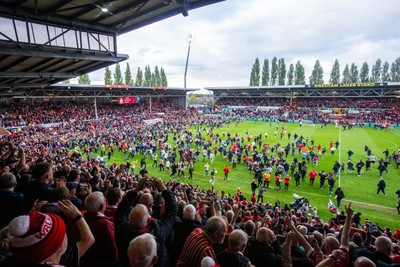 260425 - Wrexham v Charlton Athletic - Sky Bet League 1 - Wrexham fans celebrate at full time following their promotion securing victory over Charlton