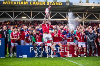 260425 - Wrexham v Charlton Athletic - Sky Bet League 1 - James McClean of Wrexham AFC lifts the Sky Bet League 1 promotion trophy following the victory over Charlton