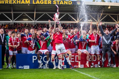 260425 - Wrexham v Charlton Athletic - Sky Bet League 1 - James McClean of Wrexham AFC lifts the Sky Bet League 1 promotion trophy following the victory over Charlton