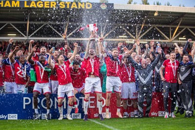 260425 - Wrexham v Charlton Athletic - Sky Bet League 1 - James McClean of Wrexham AFC lifts the Sky Bet League 1 promotion trophy following the victory over Charlton