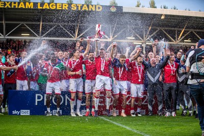260425 - Wrexham v Charlton Athletic - Sky Bet League 1 - James McClean of Wrexham AFC lifts the Sky Bet League 1 promotion trophy following the victory over Charlton