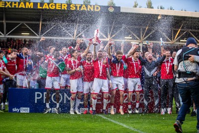260425 - Wrexham v Charlton Athletic - Sky Bet League 1 - James McClean of Wrexham AFC lifts the Sky Bet League 1 promotion trophy following the victory over Charlton