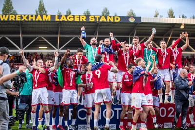 260425 - Wrexham v Charlton Athletic - Sky Bet League 1 - James McClean of Wrexham AFC lifts the Sky Bet League 1 promotion trophy following the victory over Charlton