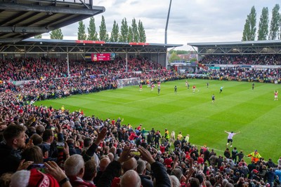 260425 - Wrexham v Charlton Athletic - Sky Bet League 1 - Wrexham fans celebrate promotion following the full time whistle