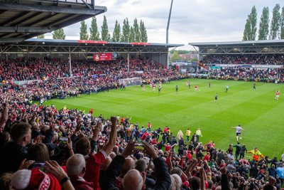260425 - Wrexham v Charlton Athletic - Sky Bet League 1 - Wrexham fans celebrate promotion following the full time whistle