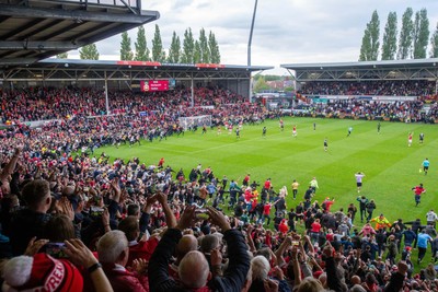 260425 - Wrexham v Charlton Athletic - Sky Bet League 1 - Wrexham fans celebrate promotion following the full time whistle