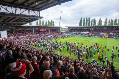 260425 - Wrexham v Charlton Athletic - Sky Bet League 1 - Wrexham fans celebrate promotion following the full time whistle