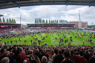 260425 - Wrexham v Charlton Athletic - Sky Bet League 1 - Wrexham fans celebrate promotion following the full time whistle