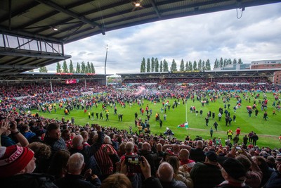 260425 - Wrexham v Charlton Athletic - Sky Bet League 1 - Wrexham fans celebrate promotion following the full time whistle