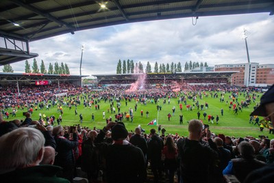 260425 - Wrexham v Charlton Athletic - Sky Bet League 1 - Wrexham fans celebrate promotion following the full time whistle