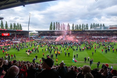 260425 - Wrexham v Charlton Athletic - Sky Bet League 1 - Wrexham fans celebrate promotion following the full time whistle